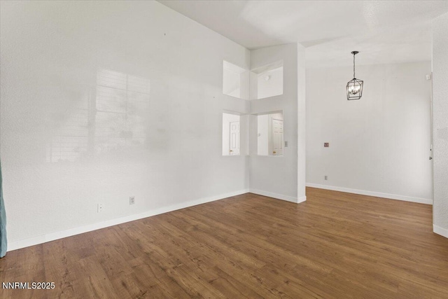 7560 Lighthouse Ln, Reno, NV 89511 - empty room featuring wood finished floors and a chandelier