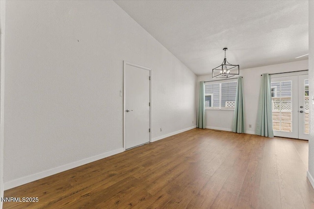 7560 Lighthouse Ln, Reno, NV 89511 - unfurnished room with a chandelier, lofted ceiling, and wood finished floors