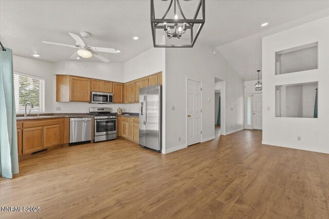 7560 Lighthouse Ln, Reno, NV 89511 - kitchen with appliances with stainless steel finishes, a chandelier, light wood-type flooring, recessed lighting, and brown cabinets