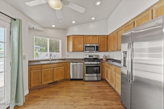 7560 Lighthouse Ln, Reno, NV 89511 - kitchen featuring stainless steel appliances, dark countertops, ceiling fan, recessed lighting, and light wood finished floors