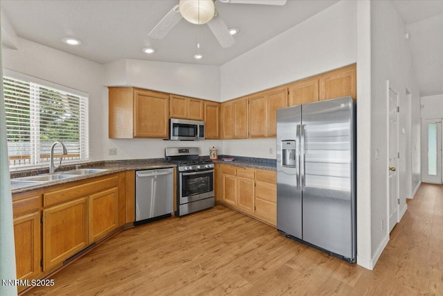 7560 Lighthouse Ln, Reno, NV 89511 - kitchen with appliances with stainless steel finishes, light wood-style floors, dark countertops, recessed lighting, and a towering ceiling
