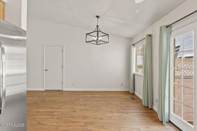 7560 Lighthouse Ln, Reno, NV 89511 - unfurnished dining area featuring light wood-style floors and a chandelier