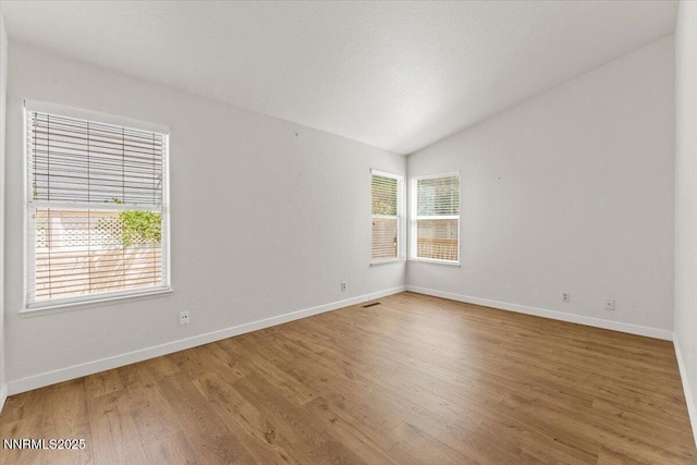7560 Lighthouse Ln, Reno, NV 89511 - empty room with wood finished floors and vaulted ceiling