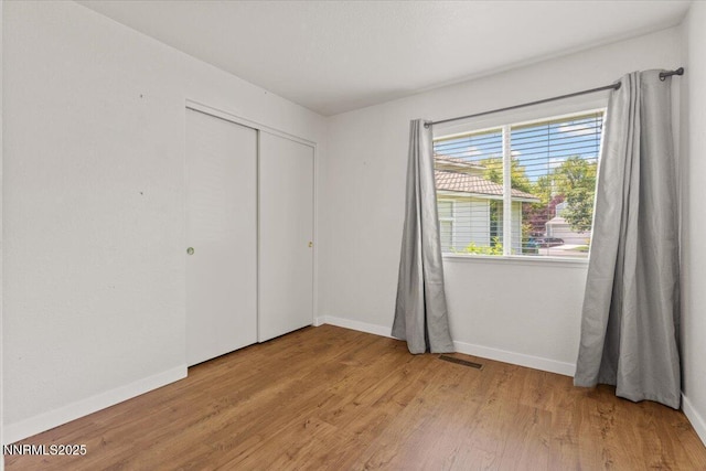 7560 Lighthouse Ln, Reno, NV 89511 - unfurnished bedroom with light wood finished floors and a closet