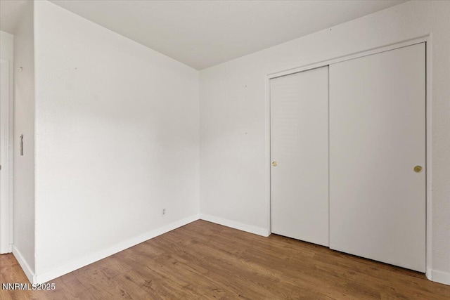 7560 Lighthouse Ln, Reno, NV 89511 - unfurnished bedroom featuring wood finished floors and a closet