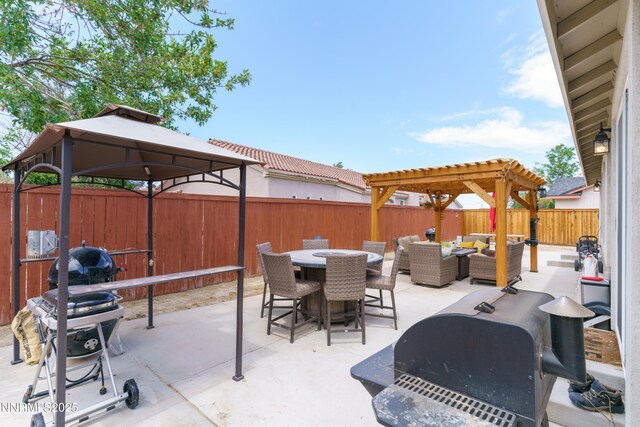1117 Dixie Ln, Fernley, NV 89408 - fenced backyard featuring an outdoor hangout area, a gazebo, area for grilling, outdoor dining area, and a patio