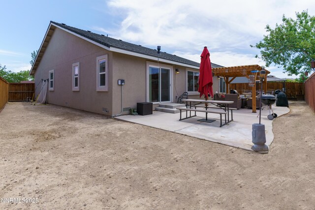 1117 Dixie Ln, Fernley, NV 89408 - back of property featuring a pergola, a patio area, stucco siding, a fenced backyard, and outdoor lounge area