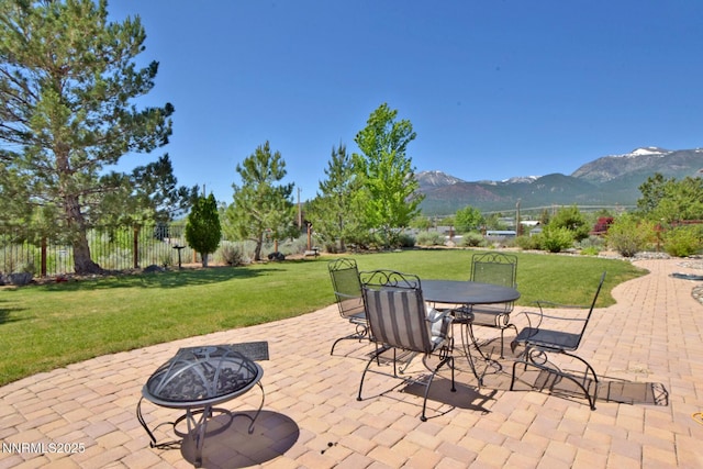 15180 Redmond Lp, Reno, NV 89511 - view of patio featuring a mountain view, a fire pit, and outdoor dining space