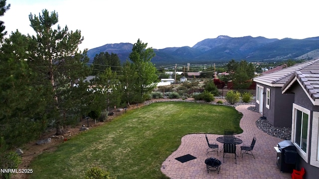 15180 Redmond Lp, Reno, NV 89511 - view of grassy yard featuring a patio area and a mountain view