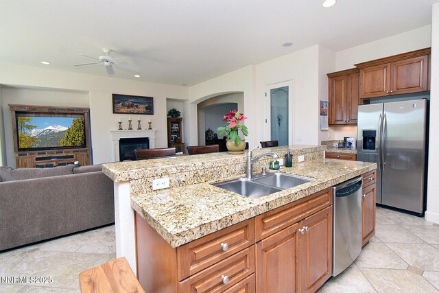 15180 Redmond Lp, Reno, NV 89511 - kitchen featuring stainless steel appliances, open floor plan, light countertops, a ceiling fan, and an island with sink
