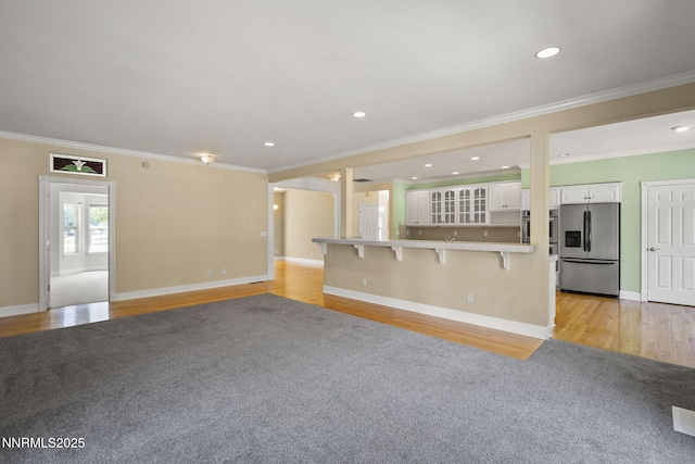 224 Foothill Meadows Ct, Genoa, NV 89411 - unfurnished living room featuring light wood-style floors, crown molding, and recessed lighting