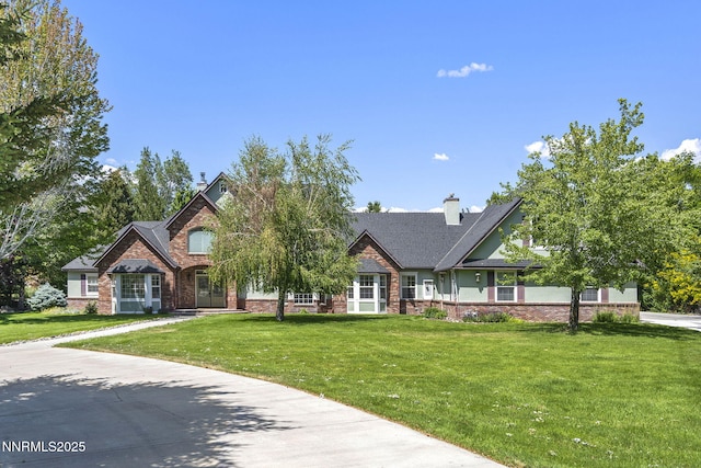 224 Foothill Meadows Ct, Genoa, NV 89411 - view of front of house with a front yard, brick siding, and a chimney