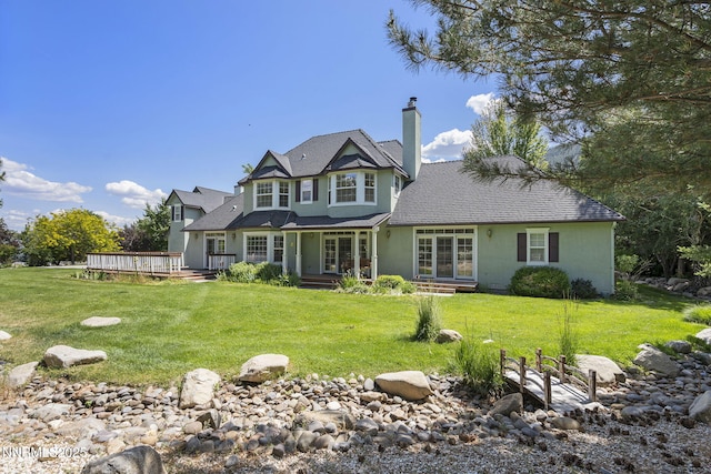 224 Foothill Meadows Ct, Genoa, NV 89411 - view of front of property featuring a chimney, a wooden deck, a front lawn, and stucco siding