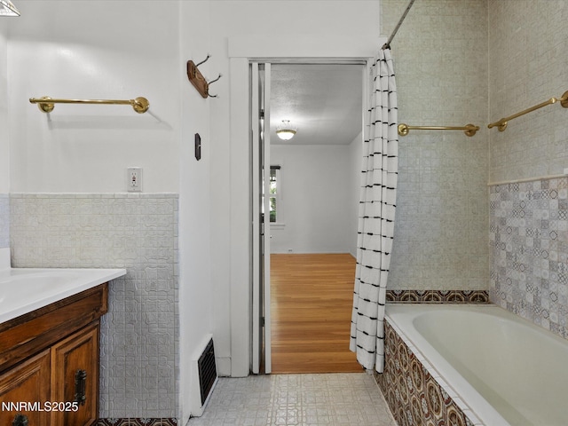 1016 Nixon Ave, Reno, NV 89509 - full bathroom featuring tiled shower / bath, vanity, and tile walls
