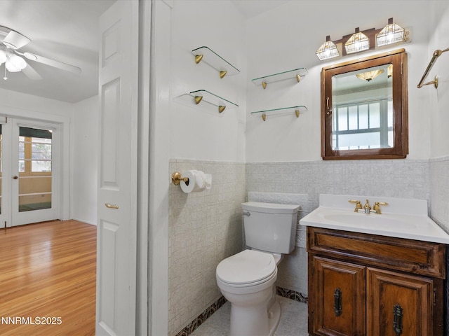 1016 Nixon Ave, Reno, NV 89509 - half bathroom featuring tile walls, vanity, wainscoting, a ceiling fan, and wood finished floors
