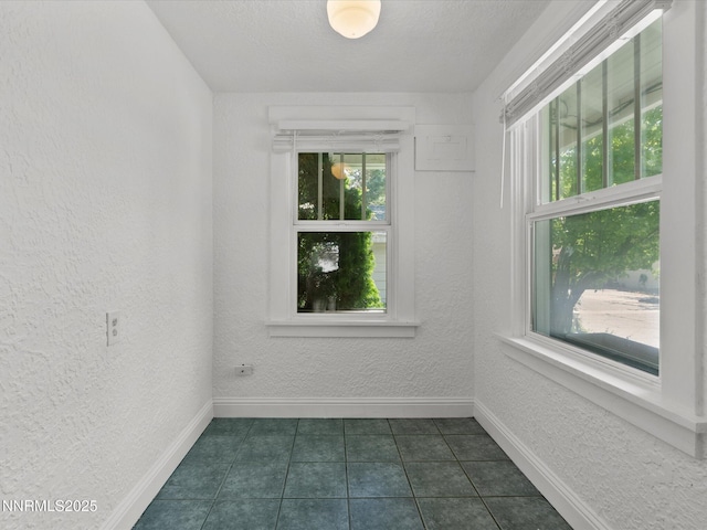 1016 Nixon Ave, Reno, NV 89509 - unfurnished room featuring dark tile patterned floors and a textured wall