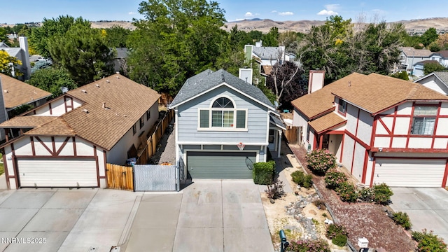 1544 Woodhaven Ln, Sparks, NV 89434 - view of front of house featuring driveway, a gate, a residential view, and a mountain view