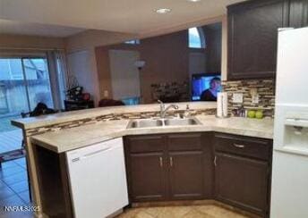 1544 Woodhaven Ln, Sparks, NV 89434 - kitchen featuring white appliances, a peninsula, light countertops, plenty of natural light, and recessed lighting