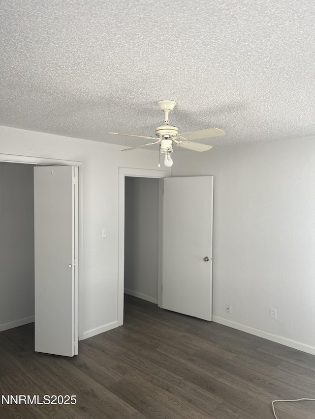 1470 Franklin Ave, Lovelock, NV 89419 - unfurnished bedroom featuring dark wood-style floors, a closet, a textured ceiling, and ceiling fan