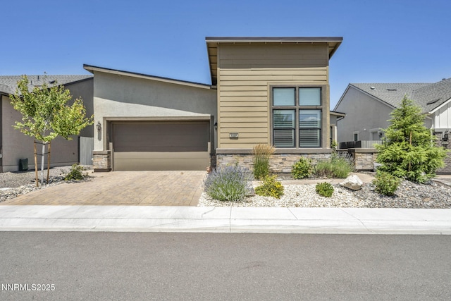 2109 Cast Iron Dr, Reno, NV 89521 - modern home featuring stone siding, an attached garage, and decorative driveway