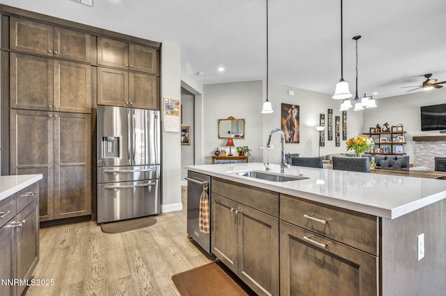 2109 Cast Iron Dr, Reno, NV 89521 - kitchen featuring stainless steel appliances, light wood-style flooring, light countertops, a ceiling fan, and open floor plan