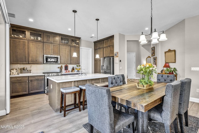 2109 Cast Iron Dr, Reno, NV 89521 - dining space with light wood-type flooring, a chandelier, and recessed lighting