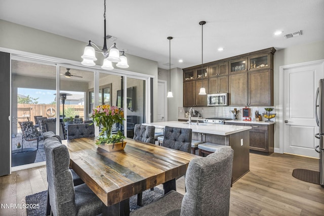 2109 Cast Iron Dr, Reno, NV 89521 - dining room featuring light wood-style flooring, ceiling fan, a chandelier, and recessed lighting