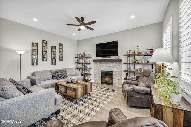 2109 Cast Iron Dr, Reno, NV 89521 - living room featuring ceiling fan, light wood-type flooring, a stone fireplace, and recessed lighting