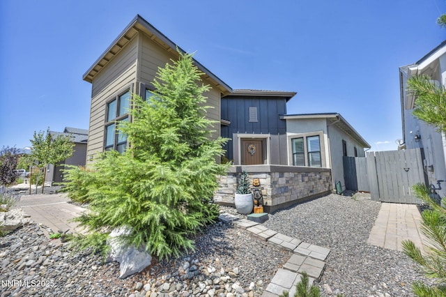 2109 Cast Iron Dr, Reno, NV 89521 - view of front of house featuring stone siding, board and batten siding, and a gate