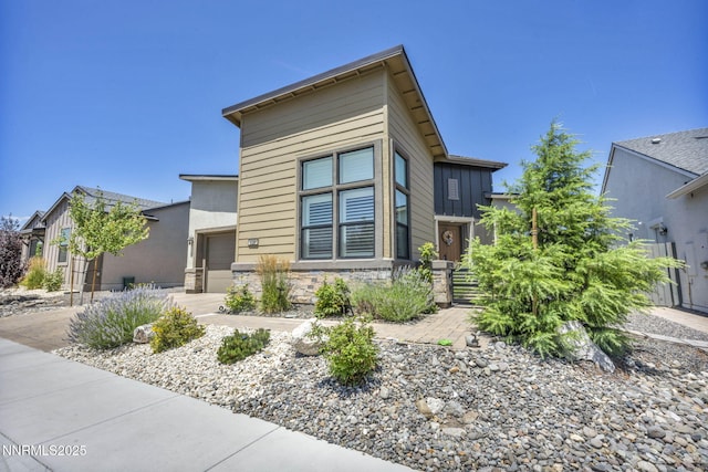 2109 Cast Iron Dr, Reno, NV 89521 - modern home featuring a garage and stone siding