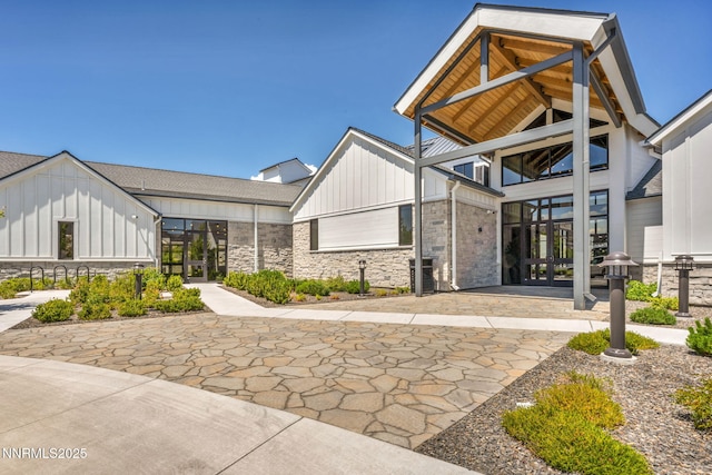 2109 Cast Iron Dr, Reno, NV 89521 - view of front of home with french doors, board and batten siding, and stone siding