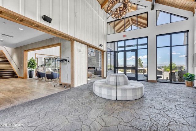 2109 Cast Iron Dr, Reno, NV 89521 - community lobby with high vaulted ceiling, wood walls, and stairway