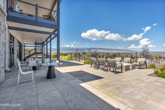 2109 Cast Iron Dr, Reno, NV 89521 - view of patio featuring stairway, a mountain view, and outdoor dining space