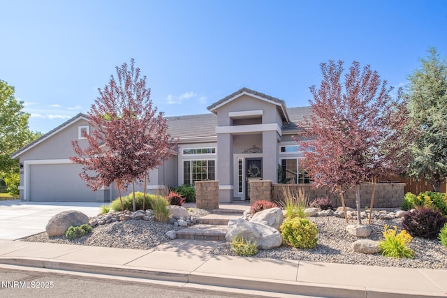 2605 Lerma Ct, Sparks, NV 89436 - view of front of home with a garage, driveway, a tile roof, and stucco siding