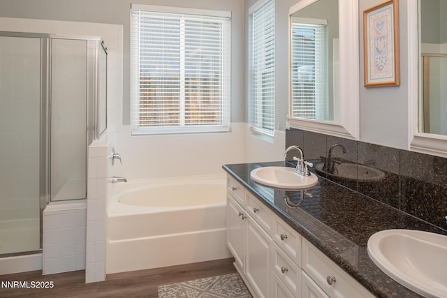 2605 Lerma Ct, Sparks, NV 89436 - bathroom with a shower stall, double vanity, a bath, wood finished floors, and plenty of natural light
