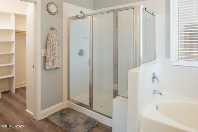 2605 Lerma Ct, Sparks, NV 89436 - full bathroom featuring a garden tub, a shower stall, a walk in closet, and wood finished floors