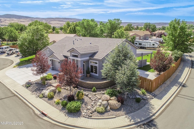 2605 Lerma Ct, Sparks, NV 89436 - view of front facade with stucco siding, concrete driveway, a tiled roof, a mountain view, and a residential view
