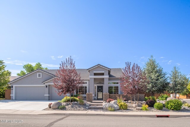 2605 Lerma Ct, Sparks, NV 89436 - view of front of home with an attached garage, concrete driveway, a tile roof, and stucco siding
