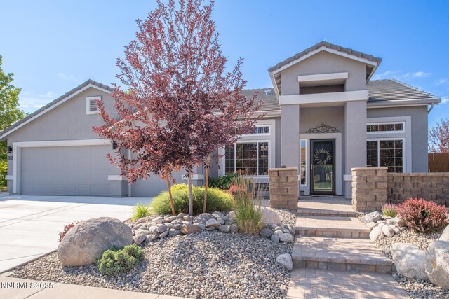 2605 Lerma Ct, Sparks, NV 89436 - view of front of property featuring a garage, concrete driveway, stucco siding, and a tile roof