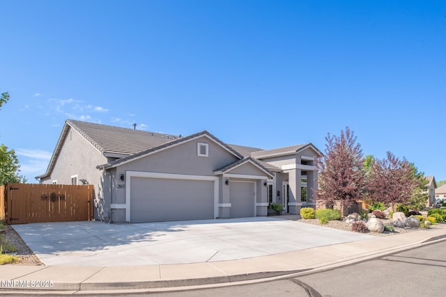 2605 Lerma Ct, Sparks, NV 89436 - view of front of home with a garage, concrete driveway, stucco siding, and a tiled roof