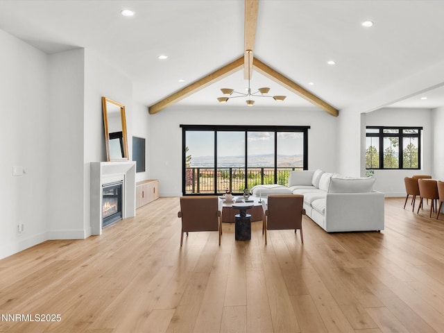 3662 Spirit Bluff Ct, Reno, NV 89511 - living area with a glass covered fireplace, light wood-style floors, and recessed lighting