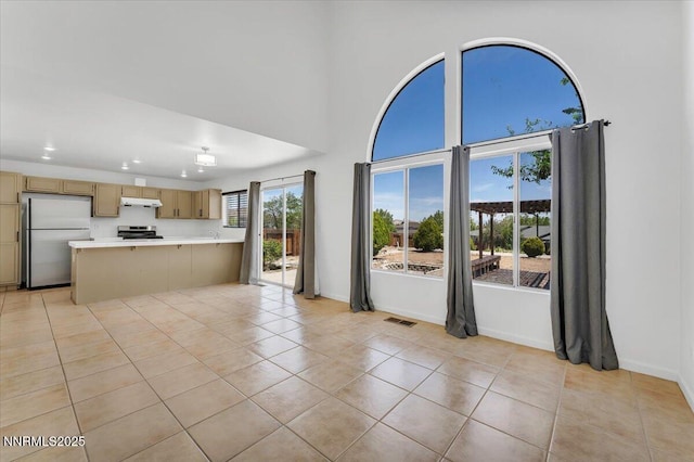 1592 Reno View Dr, Reno, NV 89523 - unfurnished living room with light tile patterned floors, recessed lighting, and a high ceiling