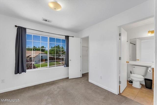 1592 Reno View Dr, Reno, NV 89523 - unfurnished bedroom with a spacious closet, carpet flooring, a closet, and ensuite bathroom