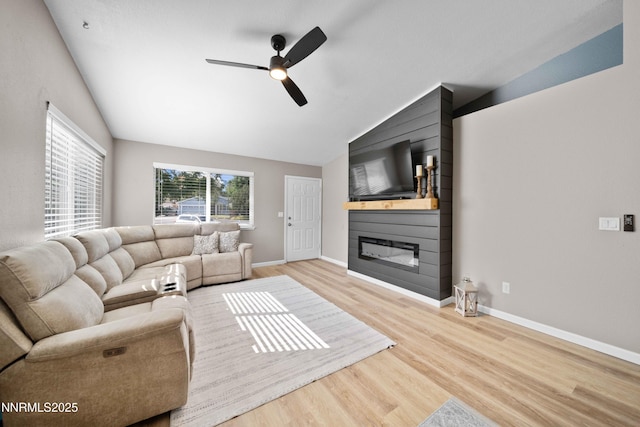 6340 E Choctaw Ct, Sun Valley, NV 89433 - living room with a fireplace, a ceiling fan, wood finished floors, and vaulted ceiling