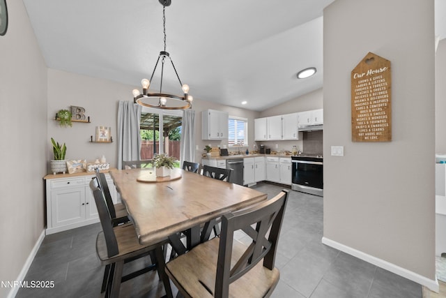 6340 E Choctaw Ct, Sun Valley, NV 89433 - dining area with a chandelier, lofted ceiling, and dark tile patterned flooring