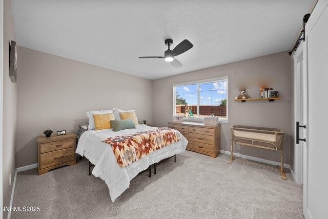 6340 E Choctaw Ct, Sun Valley, NV 89433 - bedroom with light colored carpet, a barn door, and ceiling fan