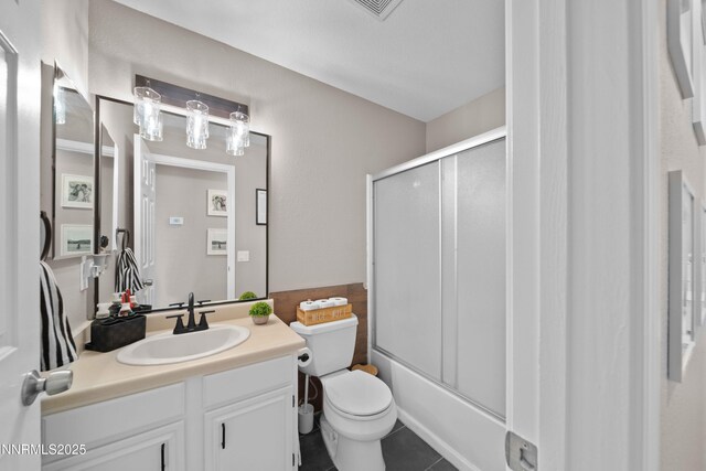 6340 E Choctaw Ct, Sun Valley, NV 89433 - bathroom featuring vanity, tile patterned flooring, and bath / shower combo with glass door