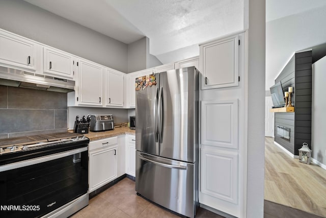 6340 E Choctaw Ct, Sun Valley, NV 89433 - kitchen with stainless steel appliances, under cabinet range hood, white cabinets, and light countertops