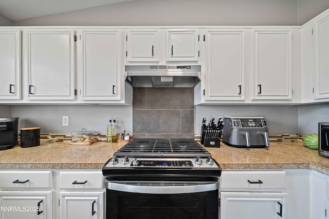 6340 E Choctaw Ct, Sun Valley, NV 89433 - kitchen with stainless steel range with gas cooktop, range hood, white cabinets, lofted ceiling, and tile counters