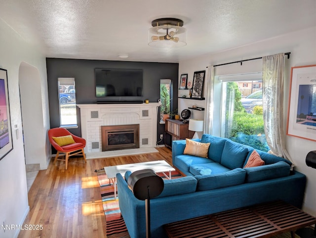 1640 Liston Ave, Reno, NV 89502 - living room featuring a fireplace, light wood-type flooring, and a textured ceiling
